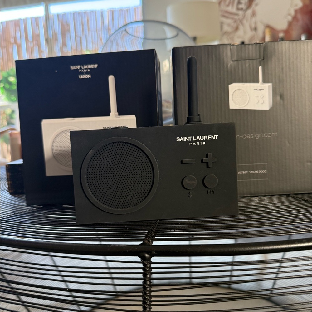 Saint Laurent Black Portable Speaker and 2 white portable speakers